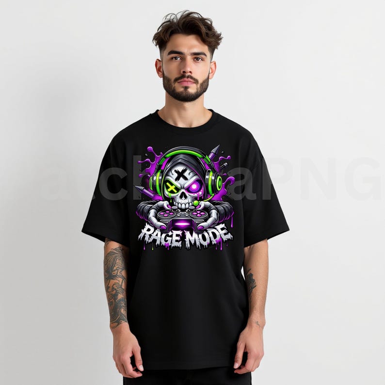 May include: Black t-shirt featuring a graphic of a skull wearing headphones and holding a game controller. The skull has a cross for an eye and the text "RAGE MODE" is below the skull in white letters.
