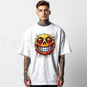 May include: White t-shirt featuring a yellow smiley face with skull eyes and a wide, toothy grin. Red blood-like drips cascade from the face, with black splatter details. The graphic is centered on the shirt.