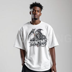 May include: White t-shirt with a graphic of a grim reaper holding a scythe, with the text "BREAK TIME". The reaper has a skull face with red eyes and is wearing a hooded cloak. The design is in black and grey.