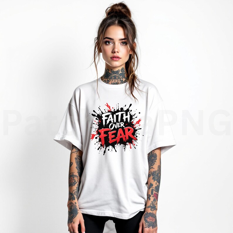 May include: White t-shirt with the words "Faith Over Fear" in red and black, surrounded by a splash design. The shirt has short sleeves and a crew neck.