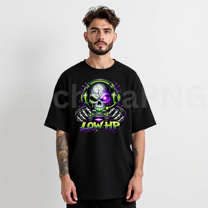 May include: Black t-shirt featuring a neon green and purple skull wearing headphones and holding a game controller. The skull has a cracked design and the text "LOW HP" is below the controller.