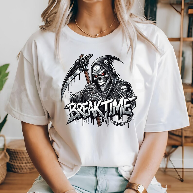 May include: White t-shirt with a graphic of a grim reaper holding a scythe, and the words "BREAK TIME". The reaper has red eyes and wears a hooded cloak. The design includes a chain. The graphic is in shades of grey and black.