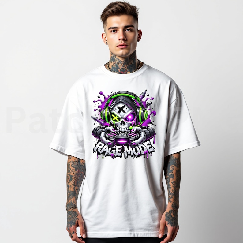 May include: White t-shirt featuring a skull graphic wearing headphones and holding a game controller. The skull has purple and green accents, with the words "RAGE MODE" below the skull in a dripping font.