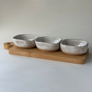 Set of 3 small handmade ceramic bowls in speckled white with wooden board image 1