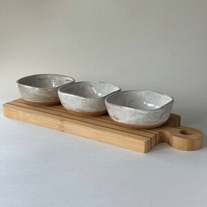 Set of 3 small handmade ceramic bowls in speckled white with wooden board image 2