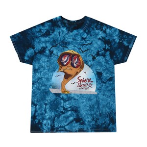 May include: A blue tie-dye t-shirt with a graphic of a man wearing sunglasses and a hat. The graphic is in front of a sunset with the text "Sphere and Loathing in Las Vegas" underneath.