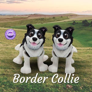May include: Two black and white border collie dog figurines with articulated legs. The figurines are standing on a green grassy field with a rolling hill in the background.