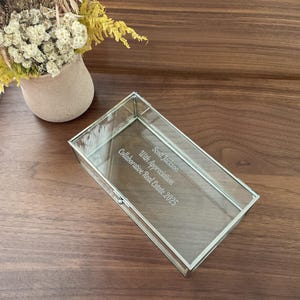 May include: A clear glass box with a silver frame. The box is engraved with the text "Scott Jackson, With Appreciation, Collaborative Real Estate 2025".