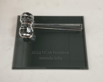 May include: A crystal gavel on a dark gray plaque with the text "2024 UCAR President Amanda Selby".