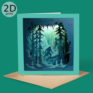 May include: A teal greeting card with a 2D print of a forest scene. The card features a silhouette of Bigfoot walking through the trees. The text "2D print" is in a white circle in the upper left corner. The card is on a brown envelope.