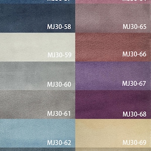 May include: A color palette of fabric swatches in various shades, including blues, grays, and purples. Each swatch is labeled with a code, such as "MJ30-57" and "MJ30-64". The fabrics appear to be soft and textured, suitable for upholstery or home decor.