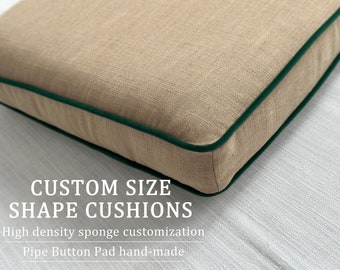 May include: A close-up of a beige linen cushion with a dark green piping detail. The cushion is on a white surface. The text "CUSTOM SIZE SHAPE CUSHIONS" is below the cushion. The text "High density sponge customization" is below the text "CUSTOM SIZE SHAPE CUSHIONS". The text "Pipe Button Pad hand-made" is below the text "High density sponge customization".