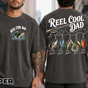a man wearing a gray t-shirt with a fishing-themed design and text on the back.