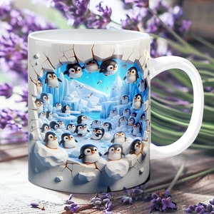 May include: White ceramic mug with a colorful image of penguins peeking out of a cracked wall. The penguins are in a snowy, icy landscape with a blue sky and sea.