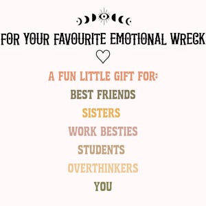 May include: A graphic print featuring the text FOR YOUR FAVOURITE EMOTIONAL WRECK, a heart icon, and the text A FUN LITTLE GIFT FOR: BEST FRIENDS, SISTERS, WORK BESTIES, STUDENTS, OVERTHINKERS, YOU. The design includes a moon phase and eye symbol.