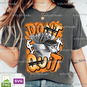 May include: Gray t-shirt with an orange and white graphic. The graphic features the words "DON'T QUIT" in an orange graffiti style, with a money bag overflowing with cash. Dollar signs are also included in the design.