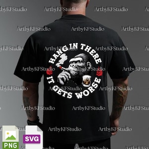 May include: Black t-shirt featuring a gorilla smoking a cigar and drinking whiskey. The graphic includes the text "HANG IN THERE IT GETS WORSE" in a circular design. The design also includes red rose accents.