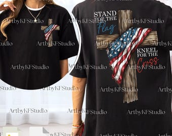 May include: Black t-shirt featuring a wooden cross design with an American flag draped over it. The text "STAND FOR THE FLAG" and "KNEEL FOR THE CROSS" are printed on the shirt. The shirt has a round neck.
