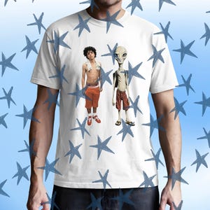May include: White t-shirt featuring a graphic of two figures: a person with curly hair and an alien. The person is wearing orange shorts and red sneakers. The alien is wearing red shorts and sandals. The shirt has a blue star pattern.