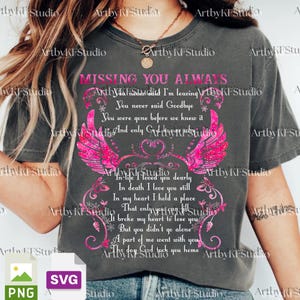 May include: Dark gray t-shirt with the text "MISSING YOU ALWAYS" and a pink winged heart design. The shirt features a poem about loss and remembrance, perfect for memorial gifts.