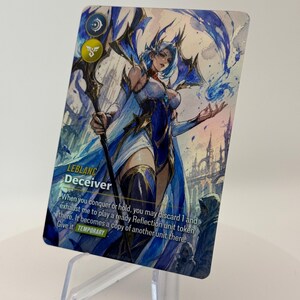 May include: A fantasy art trading card depicting a female character with blue hair and a white and blue outfit. The card is labelled "LEBLANC Deceiver" and includes game text. The card is presented on a clear plastic stand.