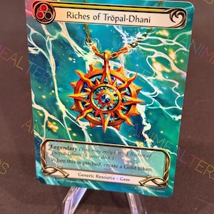 May include: A trading card titled "Riches of Tröpal-Dhani" with a gold and blue pendant design. The card features text about creating a gold token. The background has a teal and gold color scheme.