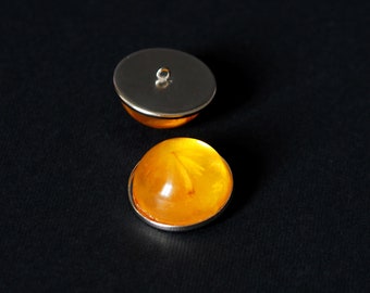 ECLIPSE - couple of buttons with a seed in amber resin.