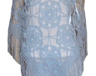 May include: A light blue crochet poncho with a fringe border. The poncho has a delicate, openwork design with a floral pattern.