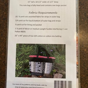May include: A black and white tote bag with a floral pattern. The bag is 15 inches tall, 18.5 inches wide, and 6.5 inches deep. The bag is fully lined and has one large pocket. The fabric requirements for the bag are listed on the back of the card.