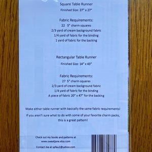 May include: A white card with instructions for making a square or rectangular table runner. The card includes fabric requirements for both sizes, which are 27 inches by 27 inches and 14 inches by 43 inches. The card also includes a website and email address for the creator.