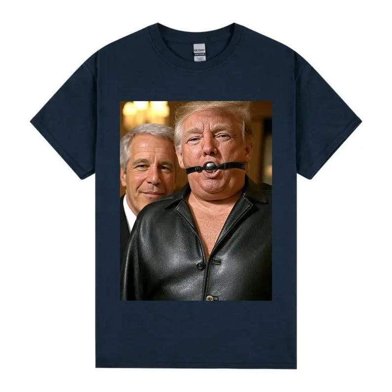 May include: A navy blue t-shirt with a graphic of two men. One is wearing a black leather jacket and a ball gag. The other man is wearing a suit. The image is centered on the shirt.