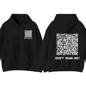 May include: Black hoodie with a white QR code graphic on the front and back. The text "DON'T SCAN ME!" is printed below the QR codes. The hoodie has a hood and a front pocket.