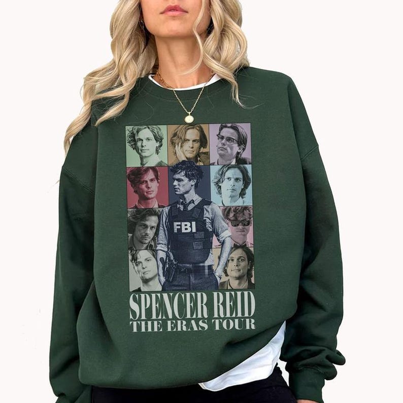 a woman wearing a green sweater with pictures of people on it
