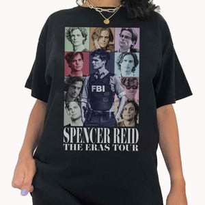 a woman wearing a black t - shirt with pictures of people on it