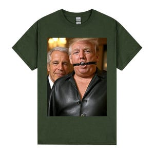 May include: Dark green t-shirt with a graphic of two men. One is wearing a black leather jacket and a ball gag. The other man is wearing a suit. The image is centered on the shirt.