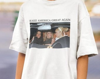 May include: White t-shirt with a photo of three women in a car. The text "MAKE AMERICA GREAT AGAIN" is printed above the photo.