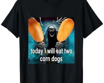 May include: Black t-shirt featuring a graphic of a skeletal figure holding two corn dogs. The figure is set against a teal background. The text "today I will eat two corn dogs" is printed below the image in white.