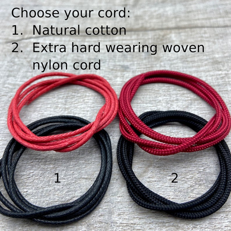 May include: Two different types of cord for making bracelets or necklaces. The first cord is a natural cotton cord, and the second cord is a woven nylon cord. The cords are shown in red and black.