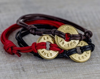 May include: Three braided bracelets with round brass charms. The charms are engraved with the words "Paulo", "Love", and "18.10.88".