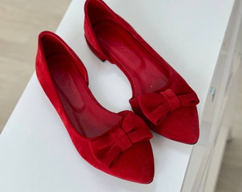 Red suede ballet flats with bow