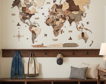 May include: A large wooden world map wall art installation featuring various shades of brown and tan wood tones, mounted above a dark wood entryway bench with coat hooks, storage cubbies, woven baskets, and a matching console table.