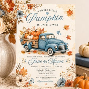 May include: A baby shower invitation card featuring a blue vintage truck carrying pumpkins, surrounded by watercolor autumn leaves and flowers. The text reads A SWEET LITTLE PUMPKIN IS ON THE WAY, Jane & Mason, Sunday January 22, 11:00 AM, and event details.