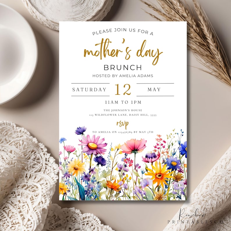 May include: A white invitation with gold text for a Mother's Day brunch. The invitation features a watercolor illustration of colorful wildflowers. The text reads "Please join us for a mother's day brunch hosted by Amelia Adams. Saturday 12 May 11am to 1pm. The Johnson's House 143 Wildflower Lane, Daisy Hill, 5555. RSVP to Amelia on 123456789 by May 1st."