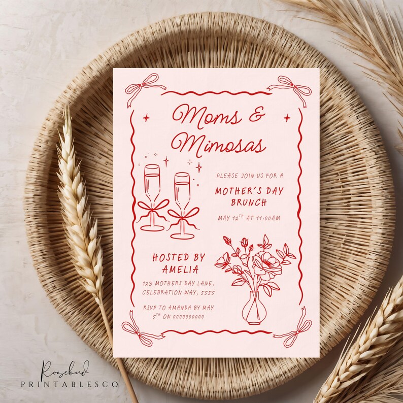 May include: A pink invitation card with red text and illustrations. The text reads "Moms & Mimosas" and "Please join us for a Mother's Day Brunch". The card also includes illustrations of champagne flutes, flowers, and a bow.