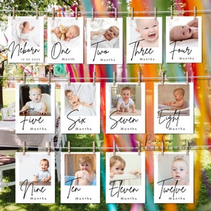 May include: Twelve white photo cards with a white floral border and a black handwritten number and the word "Months" on each card. The cards are hung on a string with clothespins. Each card has a photo of a baby at a different age, from newborn to twelve months.