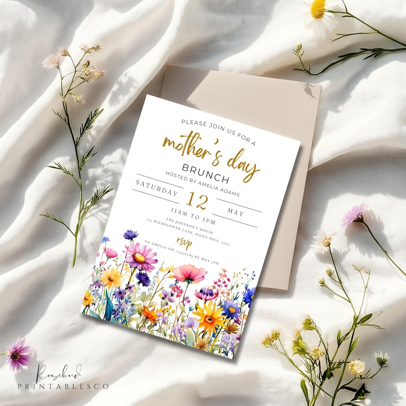 May include: A white invitation card with a floral border and gold lettering. The text reads "Please join us for a mother's day brunch hosted by Amelia Adams Saturday 12 May 11am to 1pm The Johnson's House 43 Wildflower Lane, Daily Mill, 5115 RSVP to Amelia on [phone number] by May 1st"