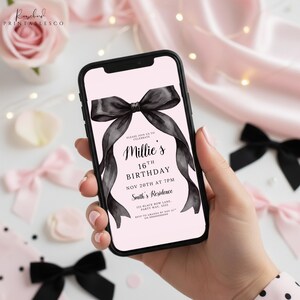 May include: A smartphone displays a pink invitation for Millie's 16th birthday. The invitation features a large black bow design and the event details: November 20th at 7 PM, Smith's Residence, and RSVP information. The phone is held against a backdrop of pink and black bows.