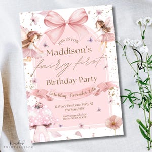 May include: A pink invitation for a fairy-themed first birthday party, featuring illustrations of fairies, a large bow, and floral details. The text reads "Maddison's fairy first Birthday Party" with the date, time, and location.