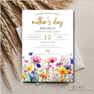 May include: A white invitation with gold lettering for a Mother's Day brunch. The invitation features a watercolor illustration of colorful wildflowers. The text reads "Please join us for a mother's day brunch hosted by Amelia Adams Saturday 12 May 11am to 1pm The Johnson's House Wildflower Lane, Daisy Hill, 3559 RSVP to Amelia on 123456789 by May 5th"