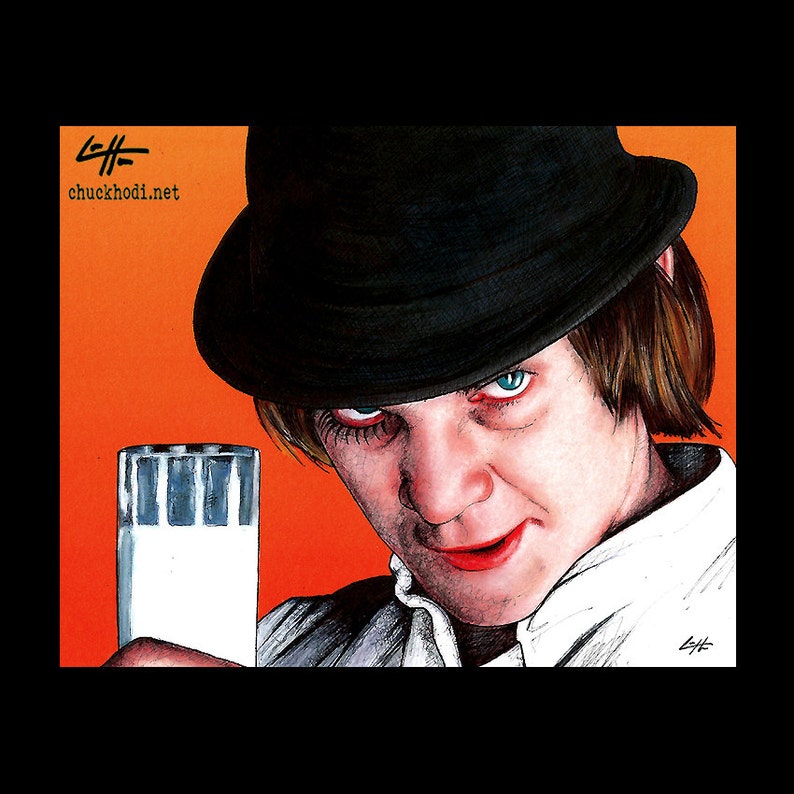May include: A man wearing a black fedora and a white shirt holds a glass of milk. He has a serious expression on his face and his eyes are looking directly at the viewer. The background is a bright orange colour.